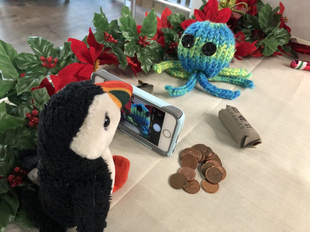 Puffy the puffin taking a picture of Brainy the octopus